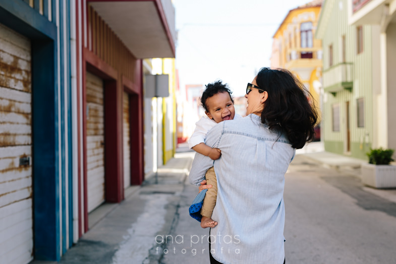 baby having fun wth mom as they walk on a colorful street