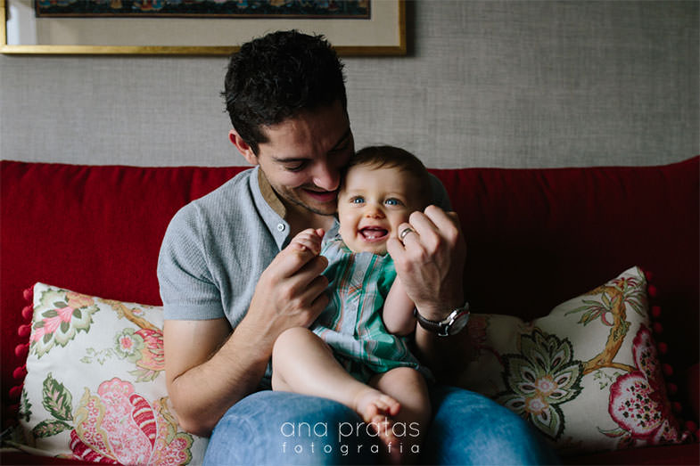 dad playing with baby son in his lap